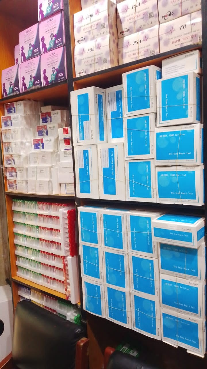 Shelves stocked with pregnancy test kits and blood collection tubes at Kingschoice Med & More